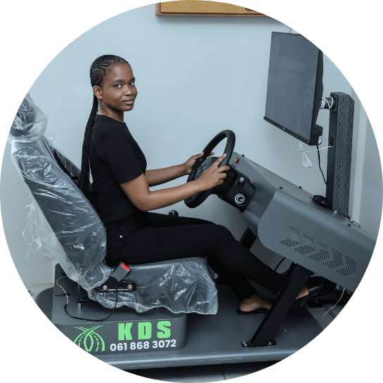 A student sitting on the driving simulator at Kimberley Driving School